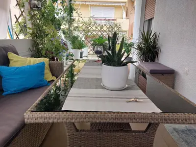 a small patio with a table and potted plants at Dream apartment in Athens