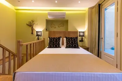 a bedroom with a large bed in a room at IPELHOME - Plaka Boutique Apartments in Athens