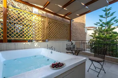 a large bath tub with a bowl of fruit in it at IPELHOME - Plaka Boutique Apartments in Athens