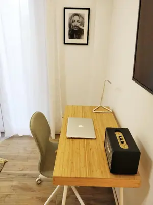 a wooden table with a laptop and a box on it at The Countess Riencourt Apartment in Athens