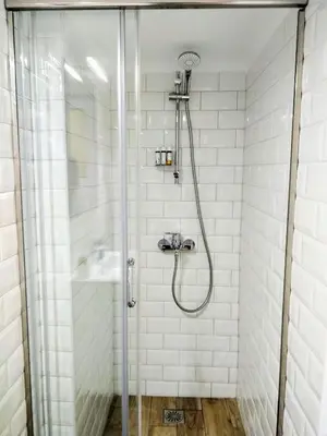 a shower with a glass door in a bathroom at The Countess Riencourt Apartment in Athens