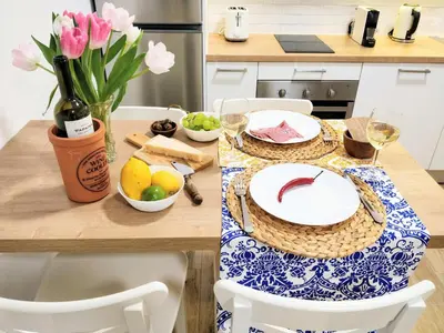 a table with a plate of food and a bottle of wine at The Countess Riencourt Apartment in Athens