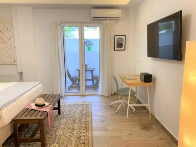 a bedroom with a bed and a desk and a window at The Countess Riencourt Apartment in Athens