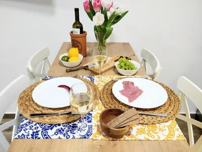 a table with two plates and glasses of wine at The Countess Riencourt Apartment in Athens