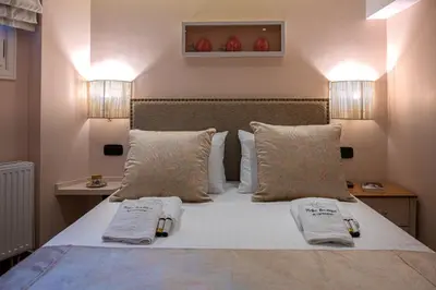 a bedroom with a bed with two towels on it at IPELHOME - Rodi Boutique Apartment in Athens