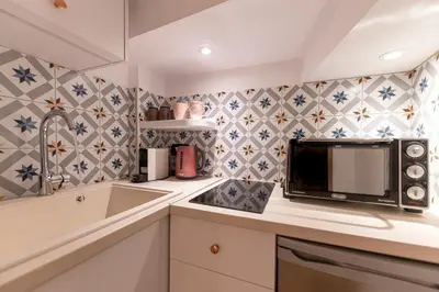 a kitchen with a microwave and a sink at IPELHOME - Rodi Boutique Apartment in Athens