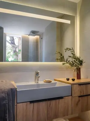 a bathroom with a white sink and a mirror at 3 Olive Trees in Anavissos