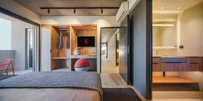 a bedroom with a bed and a bathroom at 3 Olive Trees in Anavissos