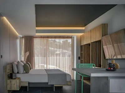 a bedroom with a bed and a window at 3 Olive Trees in Anavissos