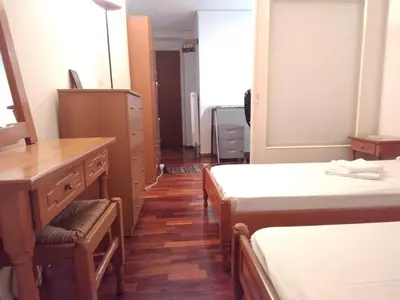 a room with two beds and a dresser in it at Studio in Athens in Athens