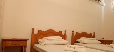two beds sitting next to each other in a room at Studio in Athens in Athens