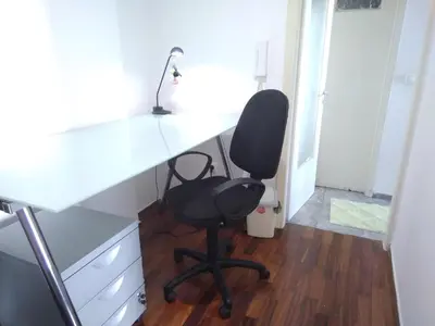 a black chair sitting at a desk in a room at Studio in Athens in Athens