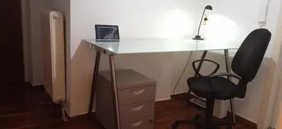 a desk with a chair and a laptop on it at Studio in Athens in Athens