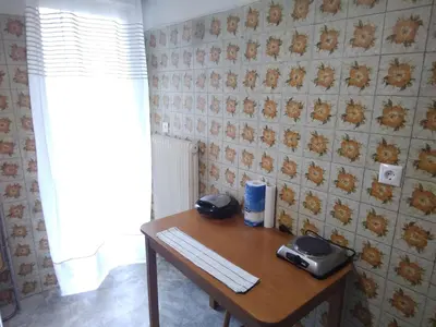 a desk with a keyboard and two phones on it at Studio in Athens in Athens