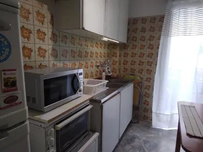 a small kitchen with a microwave and a sink at Studio in Athens in Athens