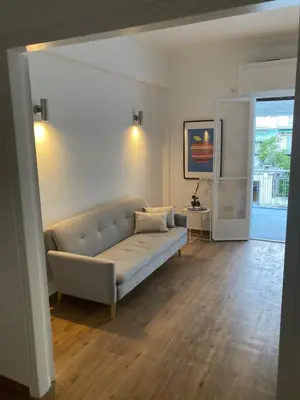 a living room with a couch and a table at Great Apartment with Terrace in Central Athens in Athens