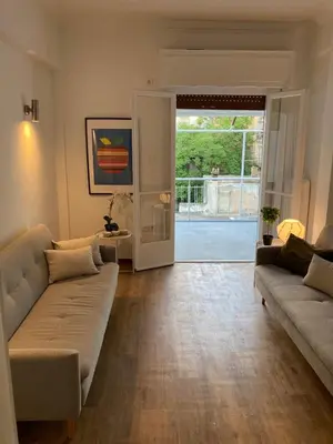 a living room with two couches and a sliding glass door at Great Apartment with Terrace in Central Athens in Athens