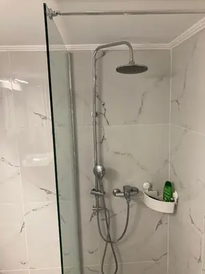 a shower with a glass door in a bathroom at Great Apartment with Terrace in Central Athens in Athens