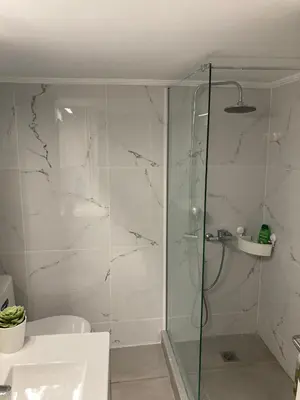 a bathroom with a shower with a glass door at Great Apartment with Terrace in Central Athens in Athens