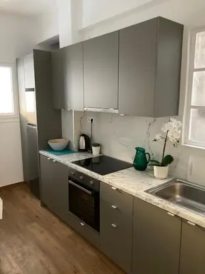 a kitchen with gray cabinets and a sink at Great Apartment with Terrace in Central Athens in Athens