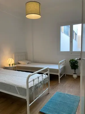 a bedroom with two beds and a window at Great Apartment with Terrace in Central Athens in Athens