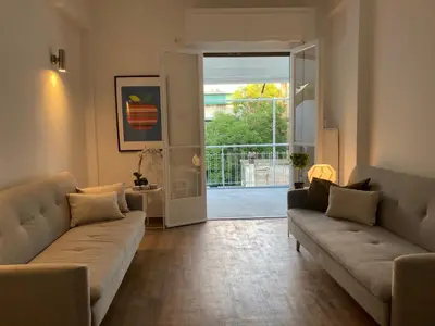 a living room with two couches and an open door at Great Apartment with Terrace in Central Athens in Athens