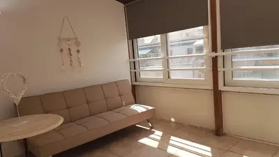 a living room with a couch and a table and windows at Sky Apartment - Athens Center, 5 BD, 4 BATH in Athens