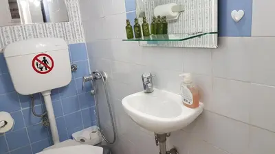 a small bathroom with a toilet and a sink at Sky Apartment - Athens Center, 5 BD, 4 BATH in Athens