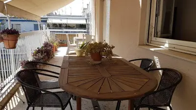 a wooden table and chairs on a balcony at Sky Apartment - Athens Center, 5 BD, 4 BATH in Athens