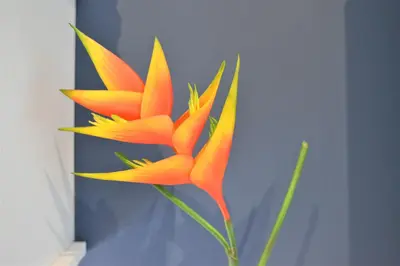 a yellow and orange flower in a vase at Cozy Apt in Ilisia with Urban Forest View in Athens