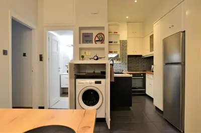 a kitchen with a washing machine in the middle at Cozy Apt in Ilisia with Urban Forest View in Athens