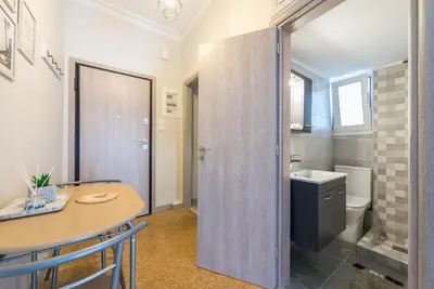 a bathroom with a table and a sink and a toilet at Athens F&K Boutique Apartment in Athens