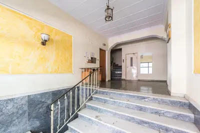a hallway with stairs and a large painting on the wall at Athens F&K Boutique Apartment in Athens