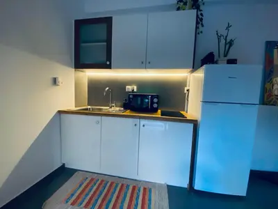 a kitchen with a sink and a refrigerator at Small Gem Studio Athens, next to metro nomismatokopeio in Athens