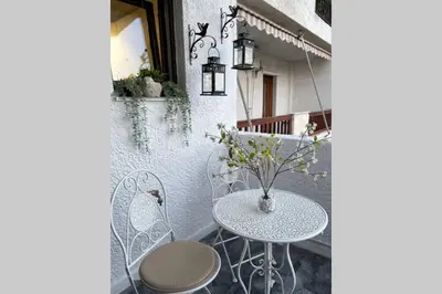 a table and chairs on a balcony with a table and chairs at RUSTIC DIAMOND new apartment near the beach in Porto Rafti