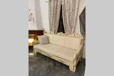a white couch in a living room with a window at RUSTIC DIAMOND new apartment near the beach in Porto Rafti
