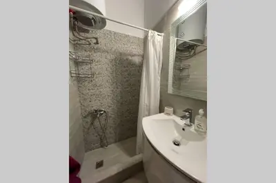 a bathroom with a sink and a shower at RUSTIC DIAMOND new apartment near the beach in Porto Rafti