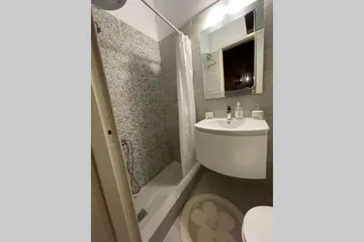 a bathroom with a white sink and a shower at RUSTIC DIAMOND new apartment near the beach in Porto Rafti