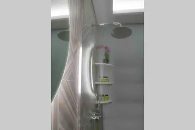 a shower with a shower curtain in a bathroom at 7 Steps Apartment Metro Syggrou Fix near Acropolis in Athens