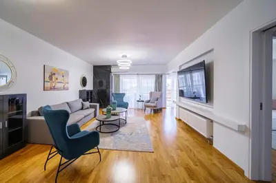 a living room with a couch and a tv at Faliro Lux Apartment By The Sea VIPGreece in Athens