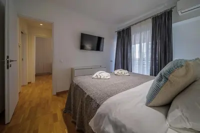a hotel room with a bed and a window at Faliro Lux Apartment By The Sea VIPGreece in Athens