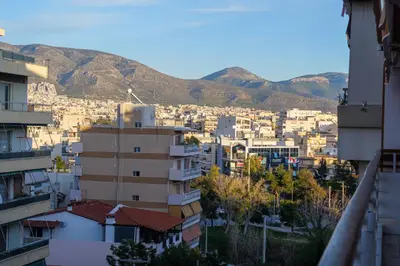 a city with buildings and mountains in the background at Faliro Lux Apartment By The Sea VIPGreece in Athens