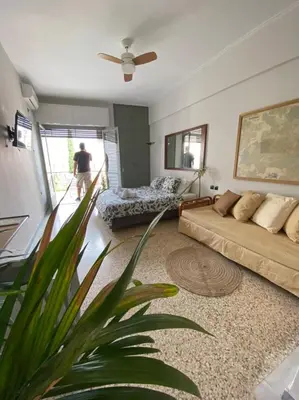 a living room with a couch and a fan at Mosaics aprtm in Monastiraki with Acropolis view in Athens