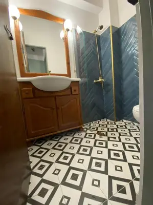 a bathroom with a sink and a mirror at Mosaics aprtm in Monastiraki with Acropolis view in Athens
