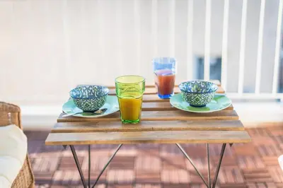 a wooden table with two glasses and bowls on it at Diamond in the Sky in Athens