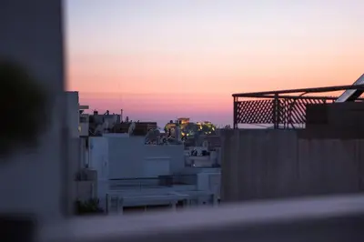 a view of the sunset from a balcony of a building at Diamond in the Sky in Athens