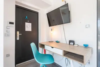 a desk with a blue chair in a room at Diamond in the Sky in Athens