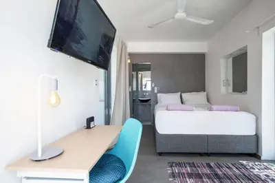 a bedroom with a bed and a desk and a tv at Diamond in the Sky in Athens