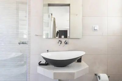 a bathroom with a large sink and a mirror at Diamond in the Sky in Athens