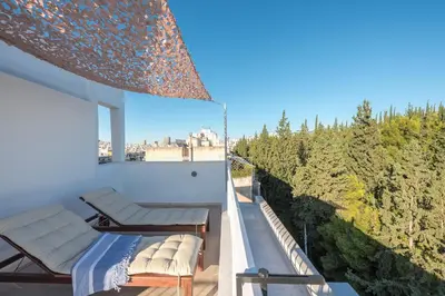 a balcony with chairs and a view of trees at Diamond in the Sky in Athens